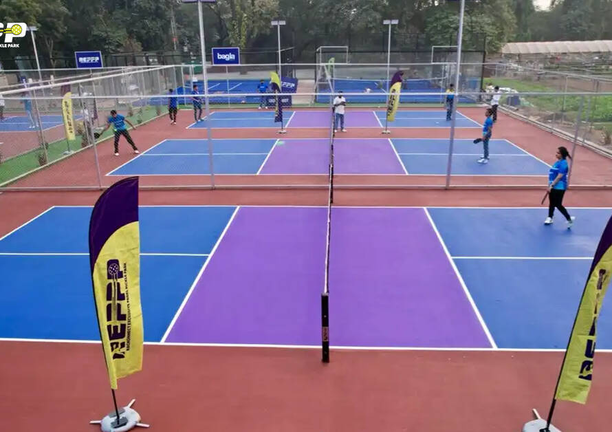 Players enjoying a Pickleball match on colorful outdoor courts